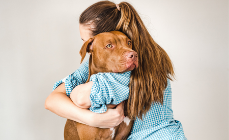 Woman hugging terminally ill dog