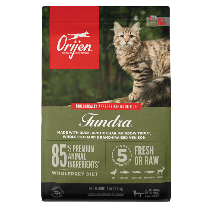 Olive green bag of Orijen Tundra dry cat food with a picture of a cat on a branch in the forest.